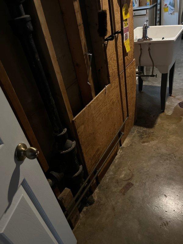 Responded to service call for utility sink drainage issue occurring during washing machine use in basement. Inspected PVC drainage system connecting both the sink and washing machine, identifying a partial clog in the shared drain line. Cleared obstruction using mechanical snake and verified proper drainage function with both appliances operating simultaneously.