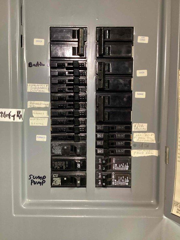 Conducted a comprehensive electrical panel inspection as part of a scheduled free electrical inspection. Documented and verified circuit breaker panel configuration, noting proper labeling for major appliances including DRYER, A/C CONDENSER, OVEN, RANGE, GARAGE, and SUMP PUMP circuits. Panel appears to be in normal working condition with no visible damage or deterioration, though showing minor signs of age.