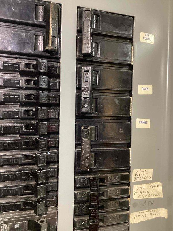 Conducted a comprehensive electrical panel inspection as part of a scheduled free electrical inspection. Documented and verified circuit breaker panel configuration, noting proper labeling for major appliances including DRYER, A/C CONDENSER, OVEN, RANGE, GARAGE, and SUMP PUMP circuits. Panel appears to be in normal working condition with no visible damage or deterioration, though showing minor signs of age.