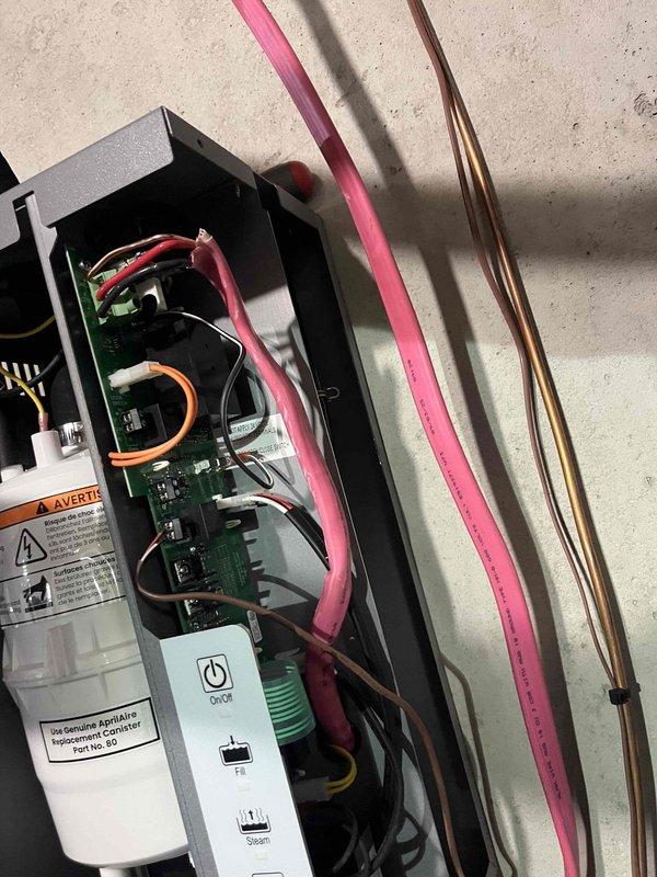 Successfully installed Model 800M steam humidifier system with proper electrical wiring connections to control board. Performed verification of all humidifier components including proper terminal connections, fill valve operation, and steam production functionality. System was tested and confirmed operational with existing HVAC equipment.