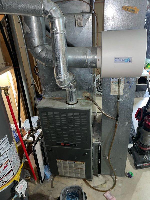 Responded to customer complaint of cold air blowing from furnace. Conducted thorough inspection of 8-year-old basement unit and associated ductwork system, which includes an Envirac air purifier attachment. Resolved issue by cleaning components and adjusting airflow settings to restore proper heating function.