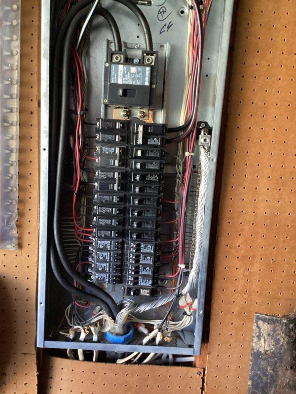 Completed comprehensive electrical inspection of residential property, testing outlet voltage/polarity with digital tester and examining main circuit breaker panel. Panel inspection revealed standard residential wiring configuration with appropriate color coding and no visible signs of deterioration or hazardous conditions.