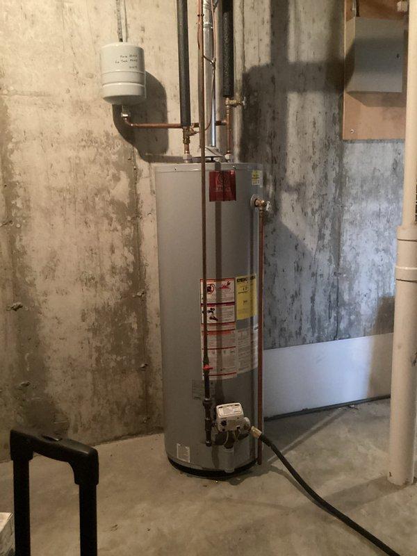 Successfully installed a 50-gallon gas water heater with permit #26PLU-04213. Installation included proper connection of copper piping, mounting of expansion tank, and setup of gas line with required fittings. All components were installed to code with appropriate valves and insulation, and ID sticker JP 000097 was applied as required.