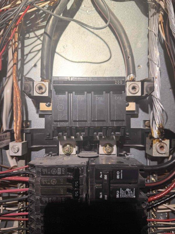 Performed a comprehensive free electrical inspection of the property, examining the exterior electrical connections and utility junction boxes with weatherproof covers and conduits. Inspected the GE circuit breaker panel containing a 200-amp main breaker and multiple subsidiary breakers of varying amperages, confirming proper wire connections and overall system condition.