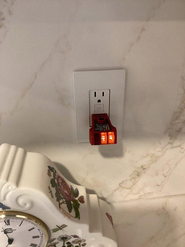 Conducted a complimentary electrical safety inspection for member, examining exposed recessed lighting fixtures in an unfinished ceiling area and testing electrical outlets throughout the home with a voltage tester. All receptacles tested showed proper wiring and grounding, with no immediate safety concerns identified in the visible electrical components.