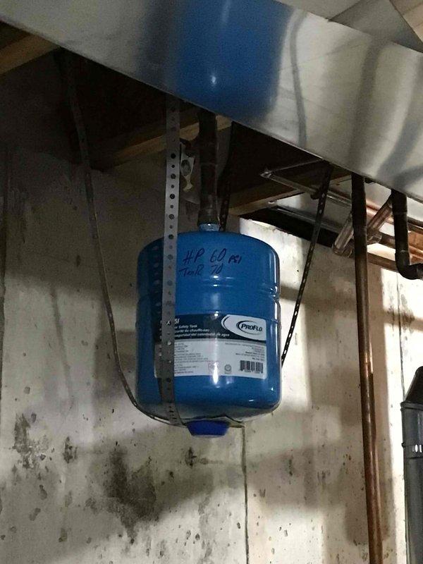 Successfully installed a 50-gallon tall gas water heater in basement utility room. Installed a blue expansion tank with proper mounting bracket to meet code requirements. All connections were completed with copper piping and included installation of the yellow gas line.