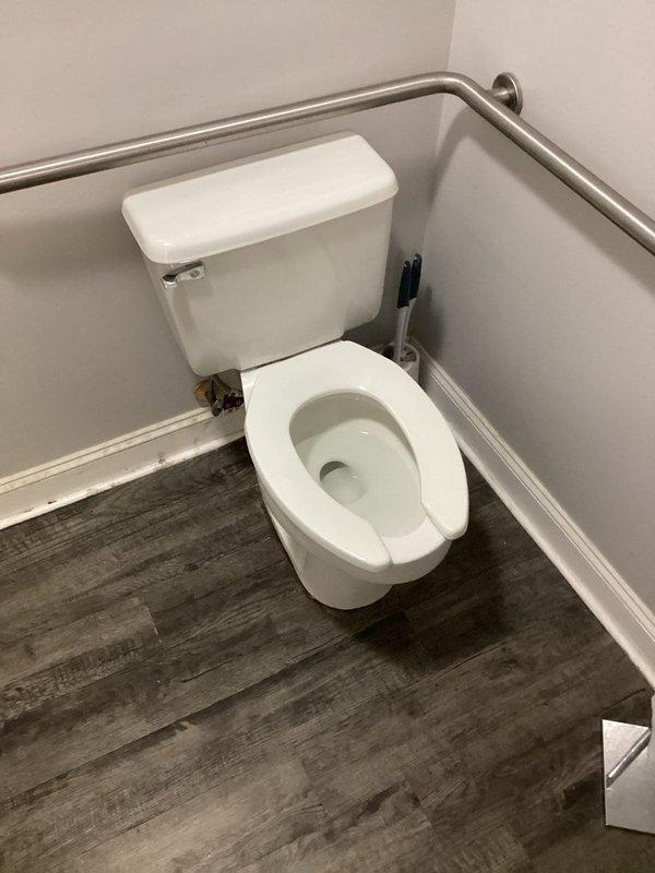 Installed new toilet in commercial bathroom with ADA-compliant grab bars. Noted damaged PVC components in packaging upon arrival which required replacement parts. Completed installation successfully and verified proper function before departure.