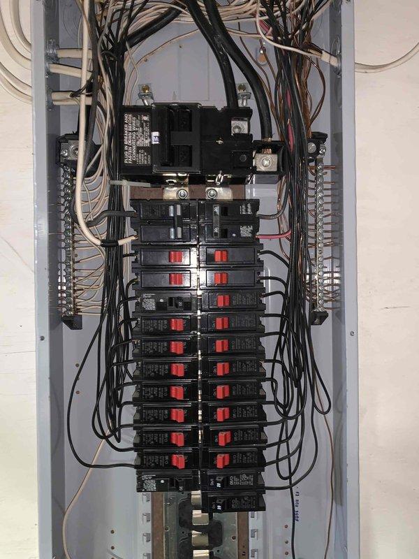 Performed comprehensive electrical maintenance audit on residential breaker panel. Inspection revealed a densely populated panel with multiple circuit breakers arranged in two vertical columns, featuring complex wiring with numerous black, white, and colored wires. Panel organization requires attention as current wiring configuration presents potential safety concerns.