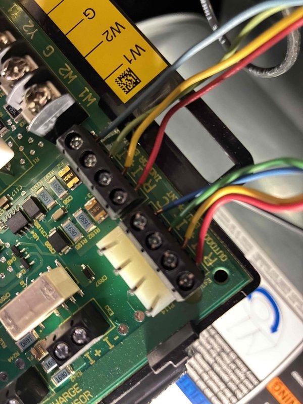 Performed diagnostic inspection on thermostat system after customer reported inaccurate temperature readings and app connectivity issues. Identified damaged wiring at the thermostat terminal with frayed insulation and exposed strands at R/C connections. Repaired wiring connections and verified proper circuit board terminal connections (W1/W2) to restore accurate temperature readings and system functionality.
