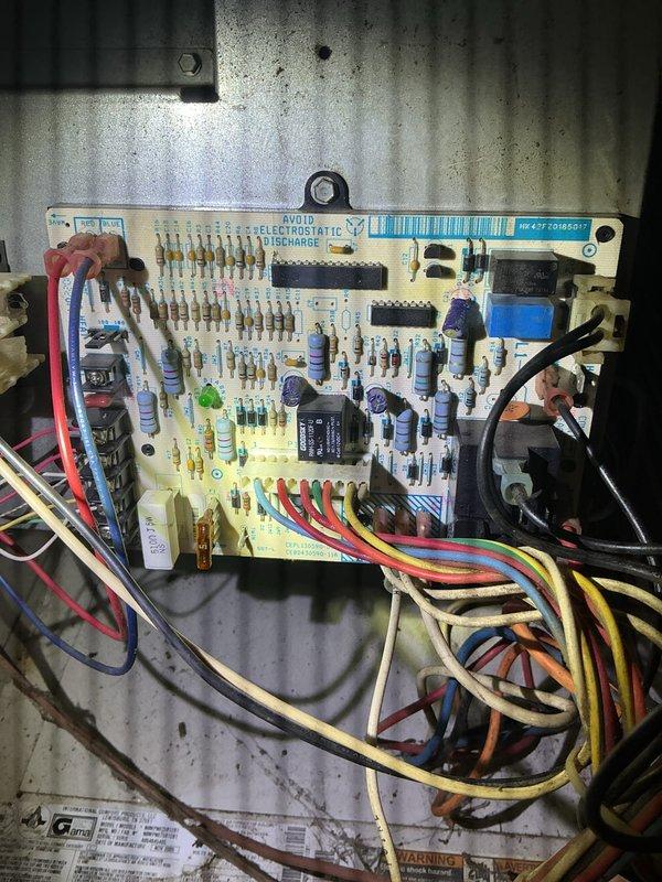 Diagnosed furnace no-heat issue on Heil unit of undetermined age. Inspection revealed faulty electronic control board with visible dust accumulation and debris on housing surfaces. Replaced defective circuit board (part #HR-F70185017) and verified proper system operation with successful heat cycle.
