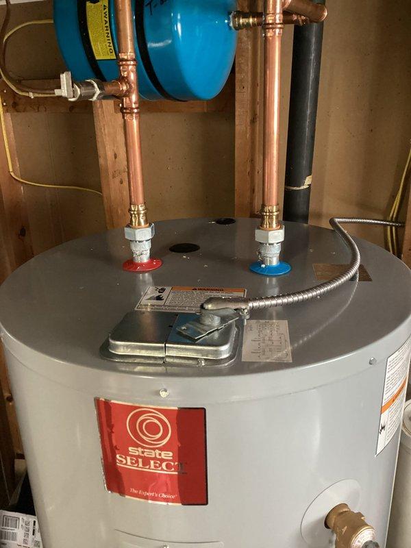 Completed electrical service work on water heater installation, including connecting the flexible metal conduit to the water heater access panel. Identified need for replacement wiring from disconnect to water heater, requiring 10/2 MC cable; scheduled return visit to complete this repair.