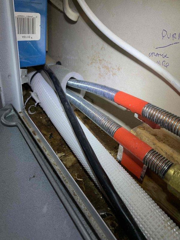 Responded to service call for a 2-month-old mini split system leaking water onto floor and walls. Inspected condensate drainage system and found improper installation of drain lines causing water to back up. Repositioned and secured condensate drain line to ensure proper flow, eliminating the leak issue.