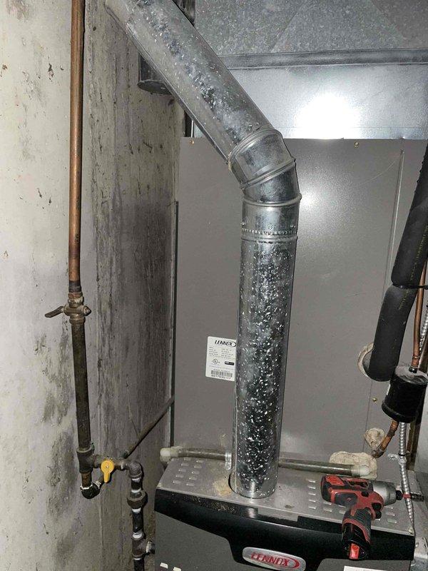 Replaced deteriorated 4" flue pipe and tee on Lennox furnace system, installing new components including 2-4" elbows, 6x4x3 flue tee, and 12ft of 4" flue pipe to restore proper venting and ensure safe operation of heating system.