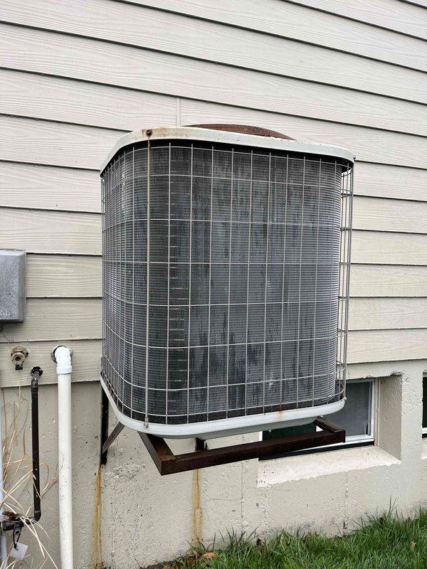 Performed comprehensive cooling maintenance on two AC systems (one <5 years old, one >15 years old). Conducted amperage testing using Klein CL800 clamp meter, recording 49.2A during operation. Inspected older condenser unit showing normal weathering and slight rust formation on upper section; both units were operational upon completion of service.