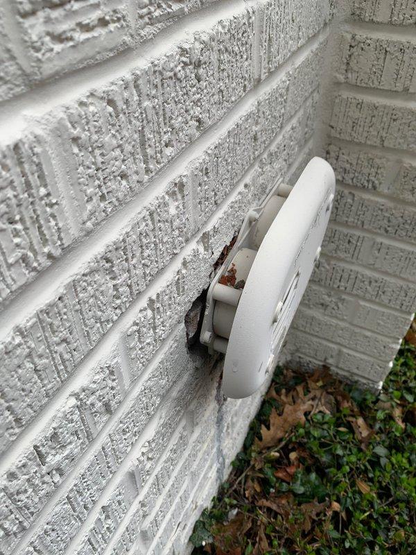 Responded to service call for leaking radiator in living room. Inspection revealed corrosion at valve connection with visible greenish patina formation. Noted improper wall mounting of adjacent utility connection with gap allowing moisture intrusion, contributing to system deterioration.