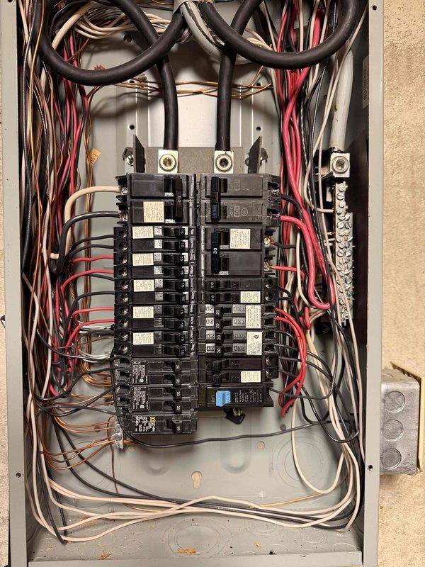 Completed free electrical inspection of residential property, examining both the main interior breaker panel and exterior service disconnect. Interior panel inspection revealed properly labeled circuit breakers with organized wiring, though minor dust accumulation was noted. Exterior service panel showed some weathering and discoloration but remains functionally sound with clear service disconnect labeling.