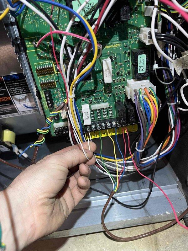 Responded to callback for Lennox furnace (7 years old) that was continuously running and overheating the home following recent heat exchanger replacement. Inspection revealed frost buildup on cooling components and issues with the control board. Traced problem to incorrect wiring connections on the SunLight circuit board where multiple wires (red, blue, yellow, white, black, pink) required proper terminal alignment. Rewired control system to correct the thermostat communication issue, tested system through multiple heating cycles, and verified proper shutdown functionality.