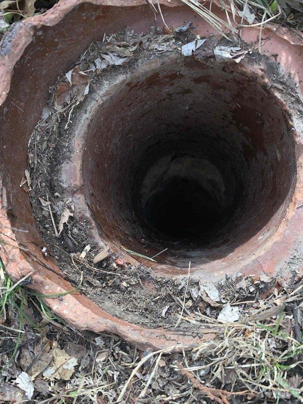 Responded to service call for main drain cleanout in basement. Upon inspection, found terracotta drain pipe with accumulated debris including soil, leaves, and organic matter both around and inside the pipe opening. Cleaned out all debris from the drain line to restore proper drainage function and prevent potential backups.