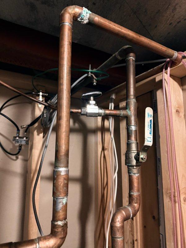 Removed existing humidifier from furnace and sealed the opening as requested. Inspected copper piping system showing signs of oxidation and corrosion at connection points. Examined electrical connections and terminal wiring on HVAC control panel, noting proper wire connections with appropriate wire nuts in place.