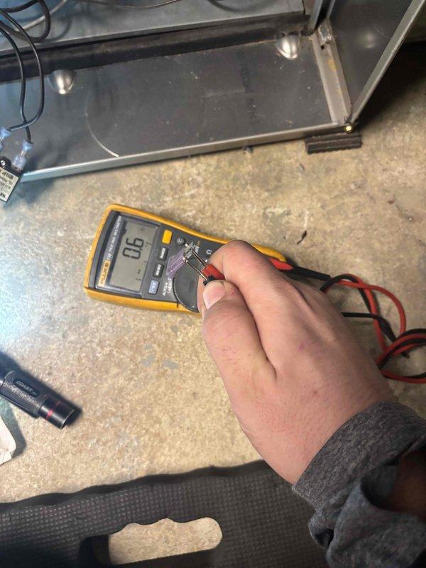 Responded to service call for furnace non-operation with error code. Performed electrical diagnostics using multimeter, measuring voltage at control board (reading 0.6). Inspected circuit board connections and DIP switch settings, identifying faulty control board as source of system failure.