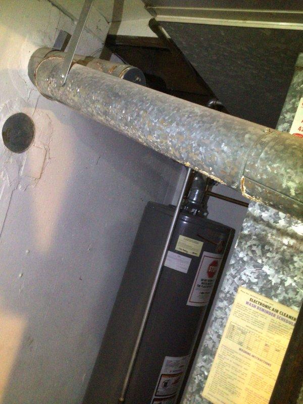 Responded to service call for water dripping from ductwork in basement. Upon inspection, identified significant corrosion and rust at duct joints and seams, indicating ongoing moisture issues. Cleared clogged condensate line and recommended sealing of duct connections to prevent future leakage and system damage.