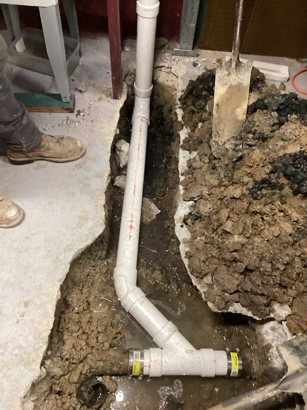 Excavated a 2'x3'x2' trench to access sewer line in basement floor, installed new PVC sewer pipe with clean-out access point, and completed the job by pouring fresh concrete to restore the floor surface.