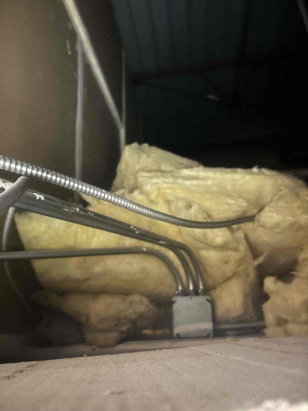 Responded to call back on recent water heater installation that was not heating properly. Upon inspection, determined that the previously recommended electrical wire replacement was insufficient to resolve the issue. Performed complete diagnostic of unit connections and components, documenting condition with photographs of heating element assembly and adjacent plumbing fixtures.