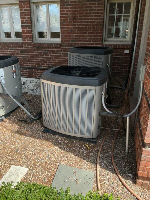 Conducted a generator estimate at residential property, examining potential installation location adjacent to existing HVAC units on gravel base against brick exterior. Photographed site conditions including proximity to building corner and current electrical service to determine appropriate generator specifications and installation requirements.