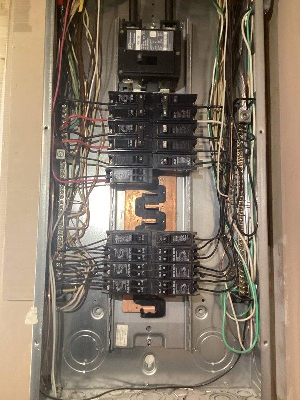Completed complimentary electrical inspection of residential service panel. Observed standard breaker configuration with visible circuit labeling, including dedicated circuits for critical systems (sump pump, furnace). Panel shows signs of aging with oxidation on bus bar and congested wiring that could benefit from organization, but no immediate safety concerns were identified.