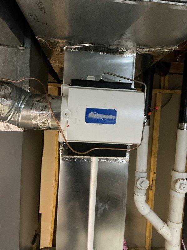 Successfully installed a Humid-Aire humidifier system in the utility space, connecting it to the existing HVAC ductwork using 6-inch round pipe and elbows. Completed all necessary connections including water supply line and low voltage wiring, with all joints properly sealed using foil tape for optimal system performance.
