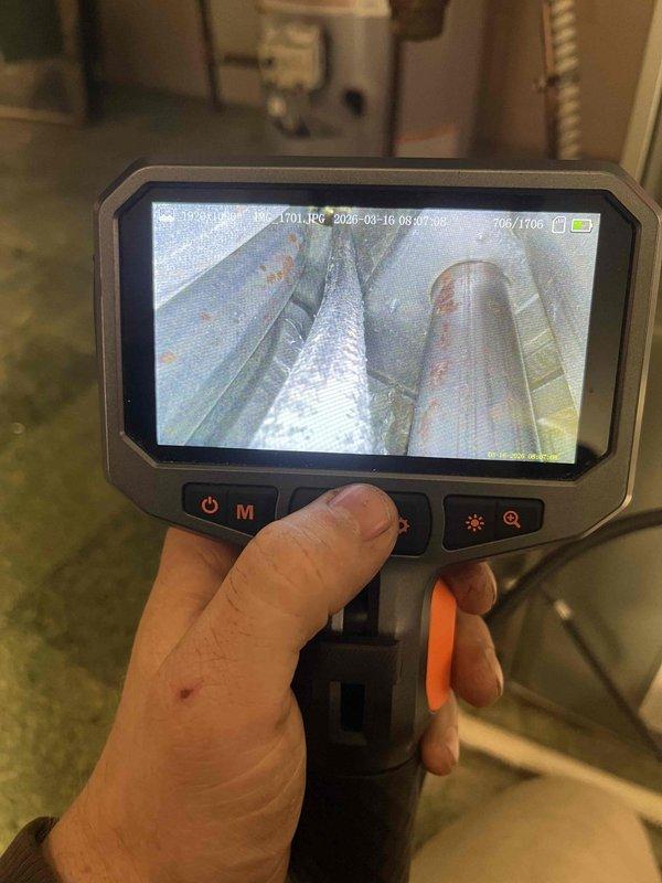 Performed diagnostic inspection on non-functioning furnace that was repeatedly shutting down. Visual inspection with camera equipment revealed significant corrosion and oxidation on heat exchanger components and ductwork. Determined system failure was due to compromised heat exchanger causing improper combustion airflow, which explained why unit would only operate with front door removed.