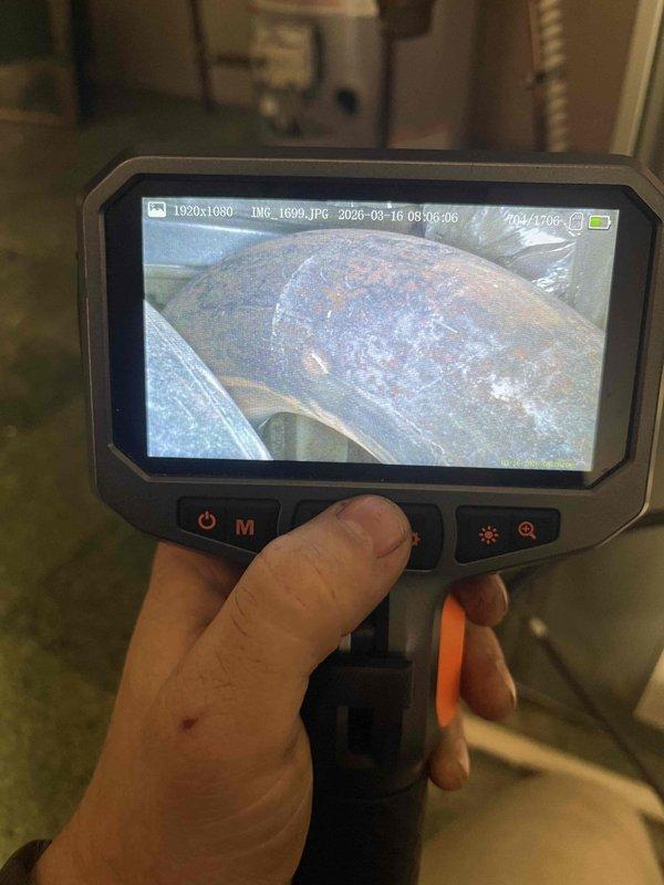 Performed diagnostic inspection on non-functioning furnace that was repeatedly shutting down. Visual inspection with camera equipment revealed significant corrosion and oxidation on heat exchanger components and ductwork. Determined system failure was due to compromised heat exchanger causing improper combustion airflow, which explained why unit would only operate with front door removed.