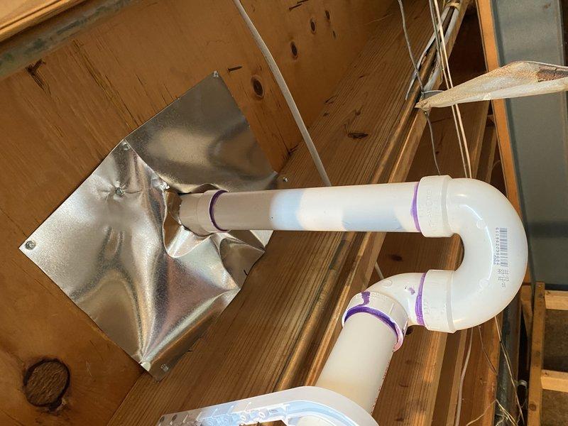 Completed installation of bathroom fixtures for second phase of project, including installation of 1/4" turn valves on water closet and lavatory, setting of shower valve, toilet installation, and lavatory connection. PVC drain piping was installed with proper P-trap configuration and venting through the structure, with all connections secured and tested for proper function.