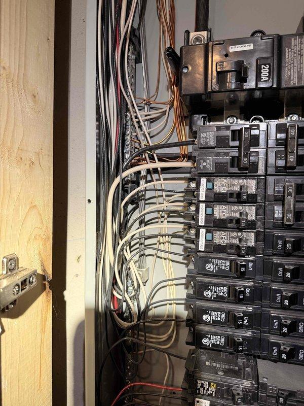 Performed comprehensive electrical inspection service including examination of exterior electric meter installation and utility connections. Conducted thorough assessment of main electrical panel (200A service) with multiple circuit breakers, verifying proper wire connections and organization. All electrical components appeared to be in standard working condition with no visible damage or safety concerns identified.