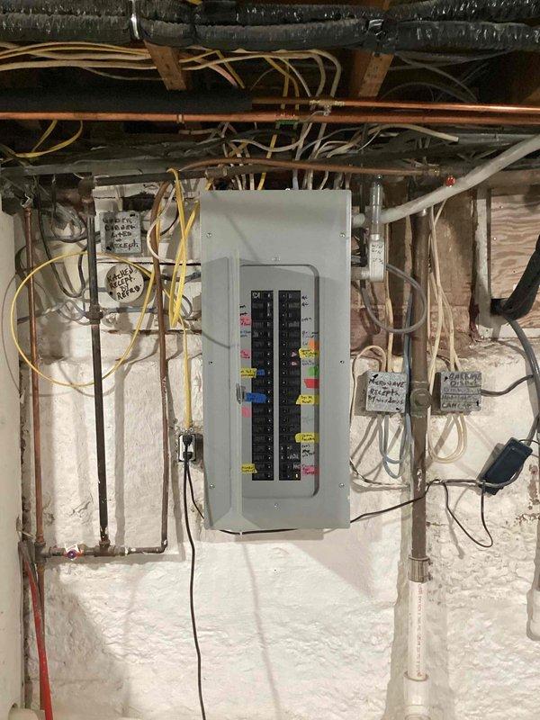 Conducted a comprehensive electrical panel inspection in the utility area, documenting a standard breaker panel installation with multiple labeled circuits. Observed extensive wiring network with proper color-coding, though noted some organizational issues with bundled wires that could benefit from improved cable management. Panel appears functional but recommended labeling improvements and wire organization for better safety and serviceability.