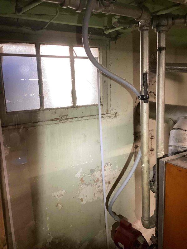 Responded to service call for Weil-McLain boiler with pump issues. Upon inspection, identified worn connection points showing significant deterioration and dust buildup at joints. Completed necessary pump repairs in aging utility room with exposed plumbing system, restoring proper functionality to the boiler system.