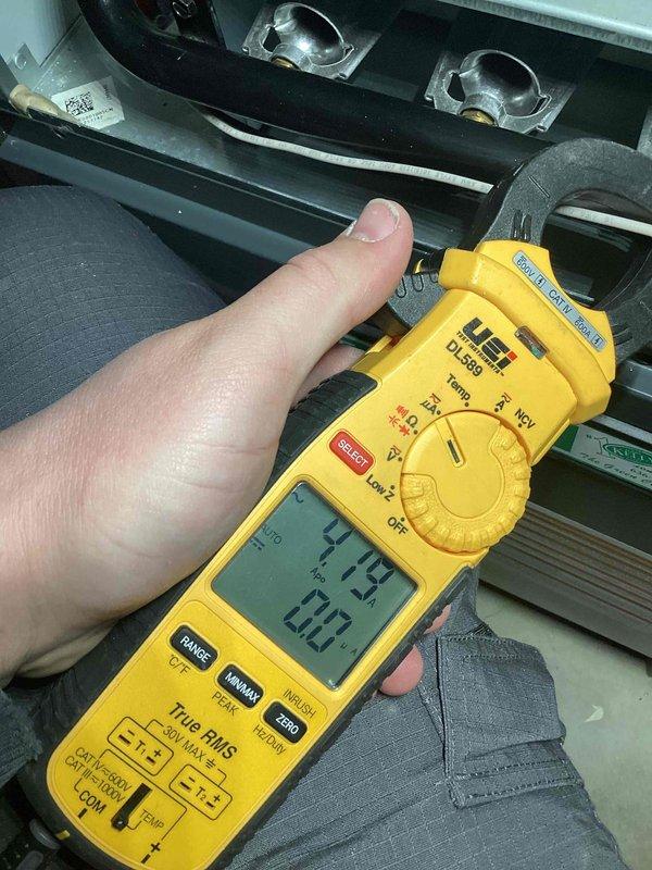 Diagnosed furnace with insufficient heat output. Measured voltage and amperage readings with UEi DL389 multimeter, confirming electrical parameters at 207V with 4.19A draw. Replaced dirty air filters which were restricting airflow, restoring proper system operation and heat production.