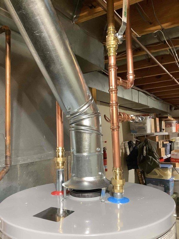 Successfully installed a new 40-gallon gas water heater with proper copper piping connections for hot and cold water lines. Removed old unit, positioned new heater, and secured the expansion tank to the ceiling joists with metal brackets. All connections were properly fitted and tested for leaks.