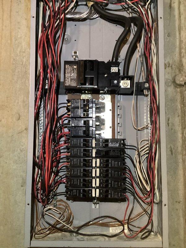Performed comprehensive electrical inspection of residential breaker panel as part of promotional service. Examination revealed panel with multiple circuit breakers and somewhat disorganized wiring configuration, including bundled power wires (red/black) and neutral/ground wires. Panel appears functional but would benefit from improved wire organization to enhance safety and maintenance accessibility.