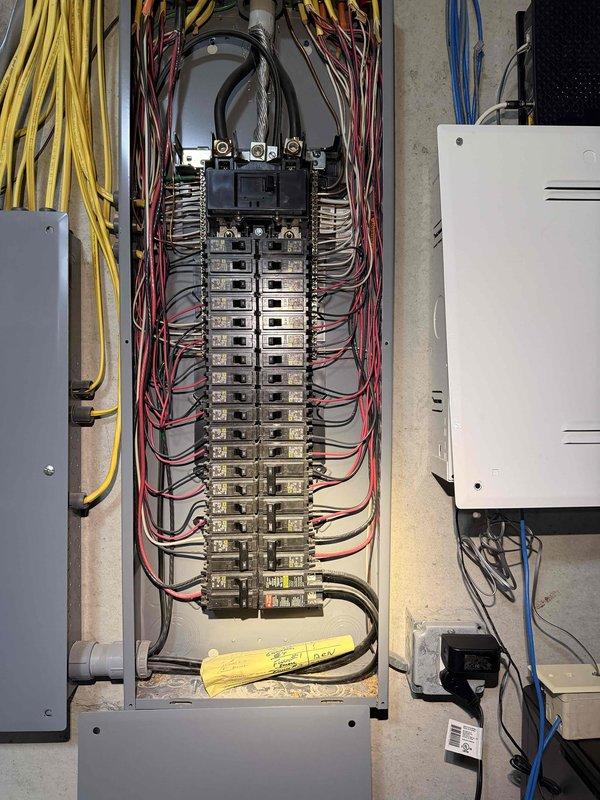 Completed home electrical audit, inspecting the exterior service entrance equipment and interior main distribution panel. Examined the meter installation, including the connection to the PVC service mast and adjacent utility box. Interior inspection revealed a properly organized breaker panel with appropriate wire routing and circuit organization, all components appeared to be in serviceable condition with no immediate safety concerns noted.