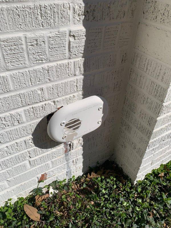 Completed exterior PVC termination repair by installing two 3" PVC 90-degree elbows and two 3" PVC street 90s at the white brick wall, securing with brick mortar for proper system venting. Removed old components and ensured system was properly functioning for both heating and cooling operations.