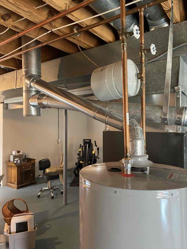 Successfully installed a new 75-gallon gas tall water heater in the basement utility room, properly connecting all required plumbing and venting components to existing systems. Completed installation of customer-supplied shower head in second floor primary suite. Applied permit identification sticker #26PLU-05133 as required.