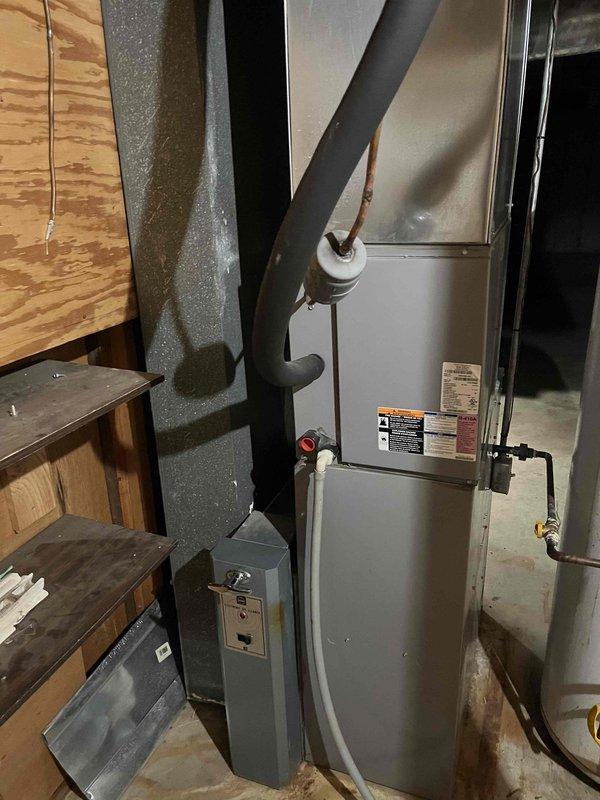 Responded to no cool call for 13-year-old basement HVAC system as second opinion. Inspection revealed electrical component issues in the control assembly, including visible corrosion on the metal chassis and potential capacitor problems indicated by the exposed cylindrical capacitor with yellow wire connections. System was serviced to restore proper cooling function.