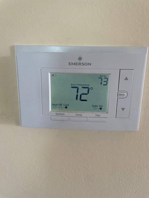 Performed diagnostic inspection on HVAC zoning system in response to customer complaint about noise during AC operation. Examined Honeywell Home zone control panel with active indicators for Zone 1 (green) and Zone 2 (red). Verified proper operation of Emerson thermostat displaying 72°F with cooling setpoint of 73°F in auto mode. Identified normal system operation with no issues requiring repair.
