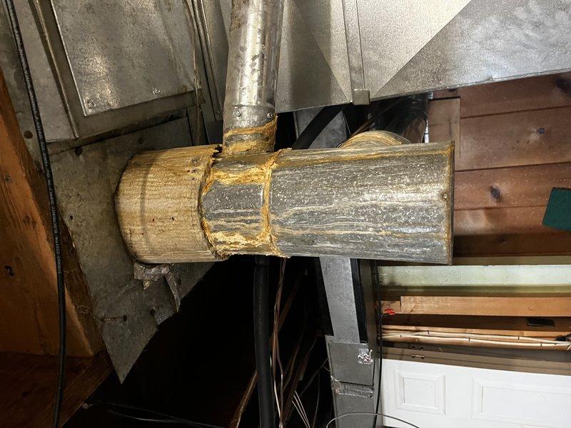 Responded to service call for dislodged flue pipe on roof. Inspection revealed significant corrosion at duct connection point in utility area, indicating moisture damage and system deterioration. Successfully reattached flue pipe and secured ventilation system to prevent future displacement.