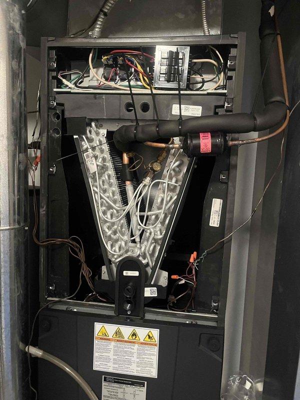 Successfully replaced defective evaporator coil under warranty on Trane air conditioning system. Installed new coil (S/N 18415KYEBF) to restore proper cooling operation. Original failed component was retained per warranty requirements.