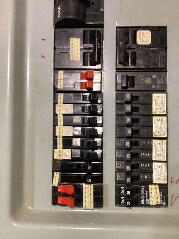 Conducted comprehensive electrical inspection of two distribution panels. First panel featured dual-column configuration with properly labeled circuit breakers including several 20A circuits and specialized red breakers. Second panel, mounted on plywood backing against masonry wall, showed signs of aging with exposed wiring bundles (black, white, red, yellow) and visible terminal connections. Both panels were operational with no immediate safety concerns identified.