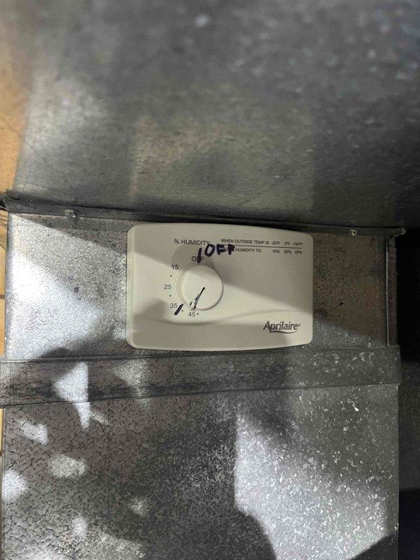 # HVAC Service - IAQ Report

Responded to service call for Aprilaire humidifier experiencing continuous water flow issue. Customer reported that humidifier pad required replacement and water was pouring through the unit, with flow persisting even after switching to summer mode, though at a reduced rate.

Upon inspection, found heavily discolored and mineral-encrusted humidifier pad with significant buildup throughout the mesh structure, indicating extended use beyond recommended service interval. The accumulation was restricting proper water distribution and drainage, causing water to overflow through the unit rather than evaporate normally. Replaced the saturated evaporator pad with new OEM filter media and verified proper installation within the black housing frame. Inspected the Aprilaire humidity control mounted on ductwork and confirmed settings were appropriate for seasonal operation. Tested water supply valve operation and drainage system to ensure proper flow control and verify