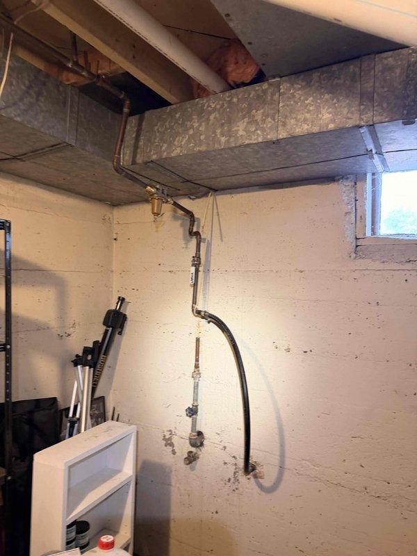 # Electrical Maintenance - Home Audit Summary

Completed complimentary electrical inspection in response to NETIC AI service request. Documented electrical infrastructure including exterior meter installation with gray PVC conduit and interior utility room electrical components.

## Work Performed

Conducted comprehensive visual inspection of residential electrical system components. Examined exterior electrical meter box mounted on vinyl siding, verifying proper installation of gray PVC conduit routing and connections. Assessed meter mounting security and conduit attachment points for code compliance.

Inspected interior utility room electrical infrastructure within unfinished basement area featuring exposed ceiling joists and white concrete block walls. Evaluated electrical routing in proximity to HVAC ductwork and plumbing installations, including vertical copper piping runs with multiple fittings and connections. Verified proper clearances between electrical components and mechanic