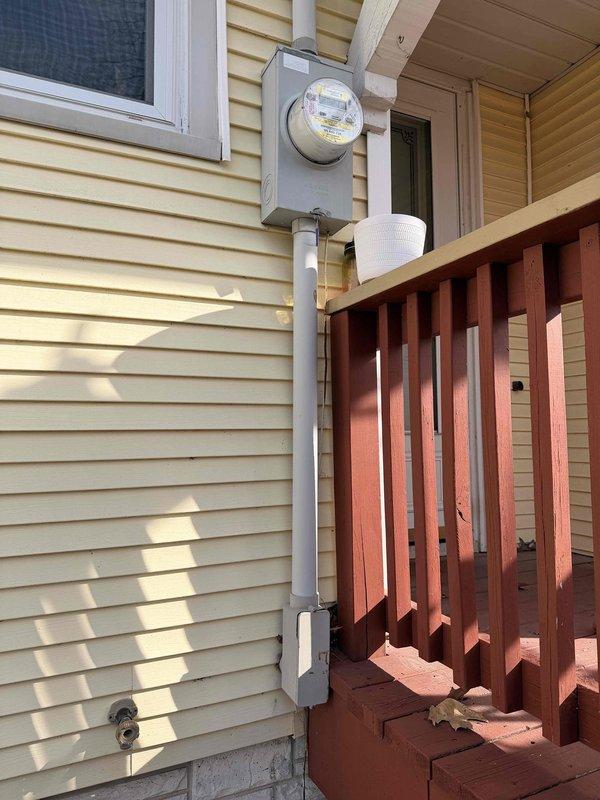# Electrical Maintenance - Home Audit Summary

Completed complimentary electrical inspection in response to NETIC AI service request. Documented electrical infrastructure including exterior meter installation with gray PVC conduit and interior utility room electrical components.

## Work Performed

Conducted comprehensive visual inspection of residential electrical system components. Examined exterior electrical meter box mounted on vinyl siding, verifying proper installation of gray PVC conduit routing and connections. Assessed meter mounting security and conduit attachment points for code compliance.

Inspected interior utility room electrical infrastructure within unfinished basement area featuring exposed ceiling joists and white concrete block walls. Evaluated electrical routing in proximity to HVAC ductwork and plumbing installations, including vertical copper piping runs with multiple fittings and connections. Verified proper clearances between electrical components and mechanic